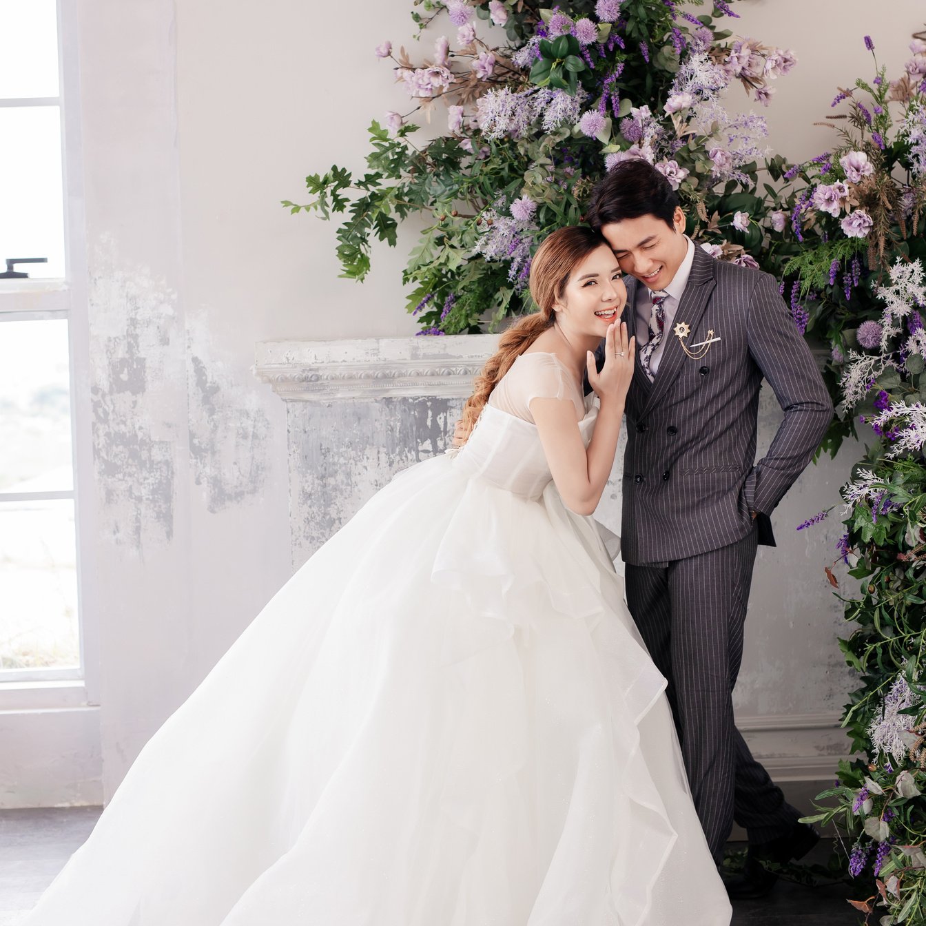 Woman in White Wedding Gown Holding Bouquet of Flowers